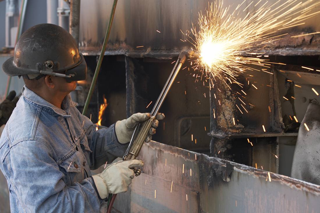 Skilled tradesperson welding in a shipyard